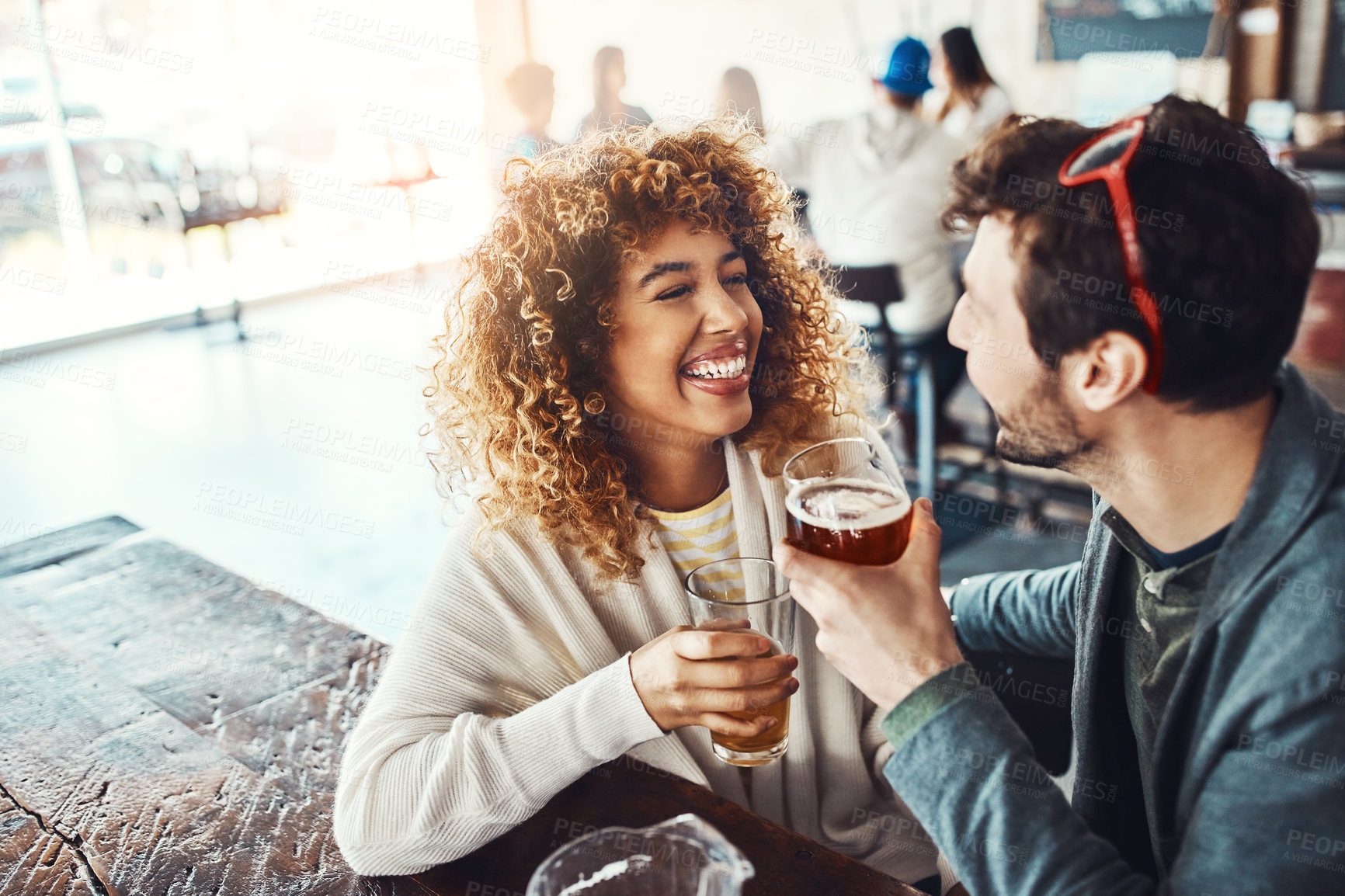 Buy stock photo Couple, beer and celebration in restaurant, smile and students with happiness, bonding together and cheerful. Relax, chilling and man with woman, alcohol and social gathering with drinks and love