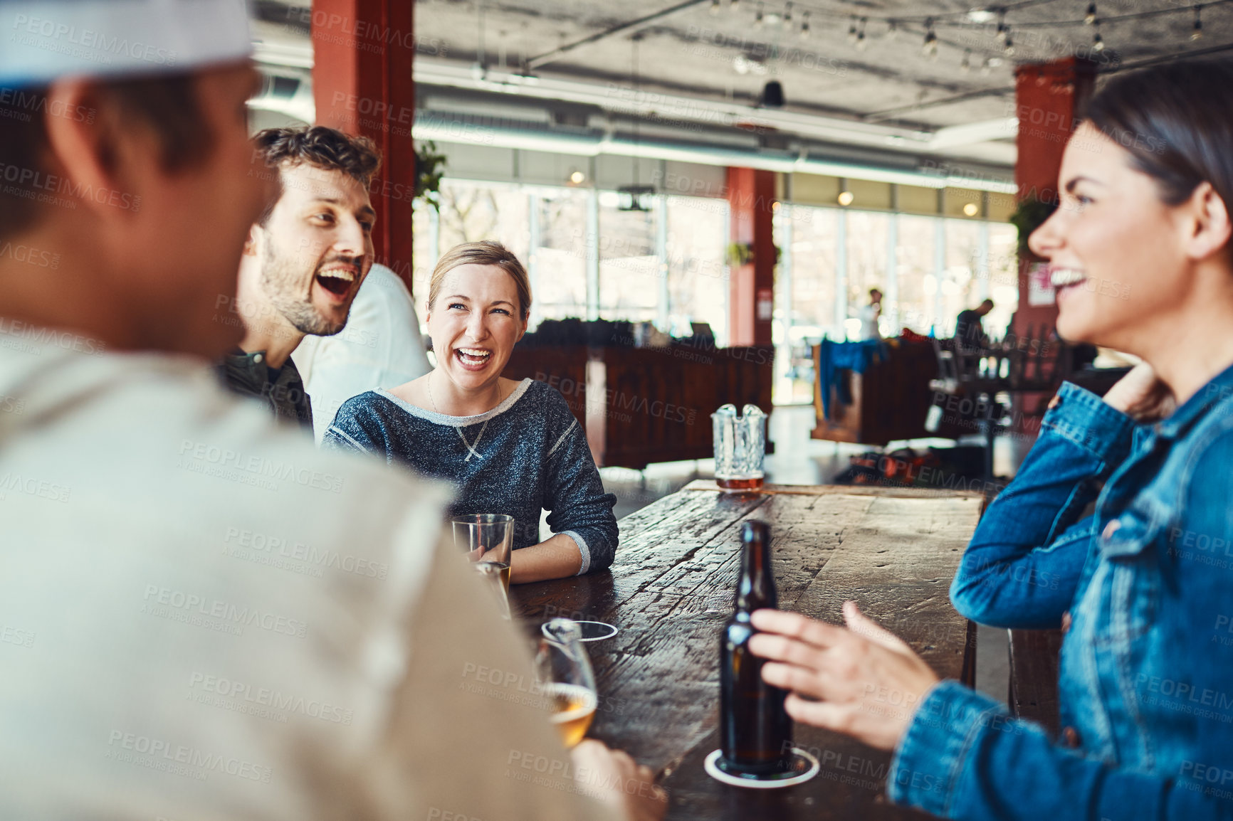 Buy stock photo Shot of a group of friends enjoying some beers at a bar