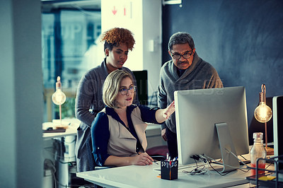 Buy stock photo Shot of a group of businesspeople working late in an office