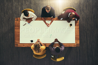 Buy stock photo High angle shot of a group of businesspeople having a meeting with the word “strategy” superimposed over them