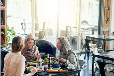 Buy stock photo Shot of a group of women getting together for lunch in a cafe