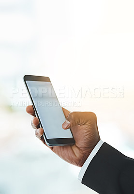 Buy stock photo Closeup shot of an unrecognizable businessman using a cellphone in an office