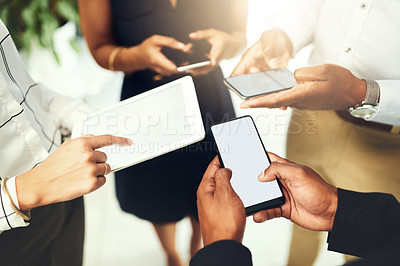Buy stock photo Closeup shot of a group of businesspeople using their digital devices in synchronicity in an office