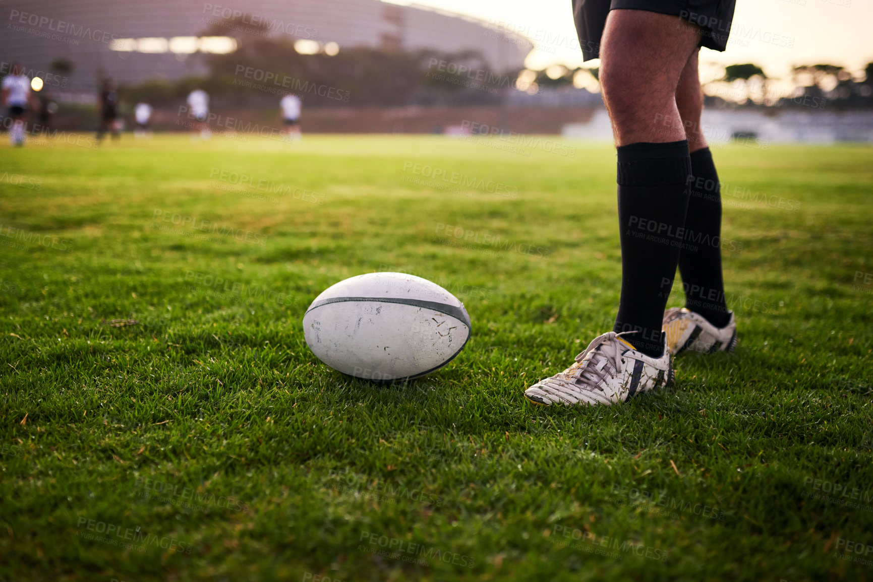 Buy stock photo Cropped shot of an unrecognizable sportsman standing alone during rugby practice in a sports club