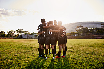 Buy stock photo Full length shot of a handsome group of sportsmen huddled together before playing rugby