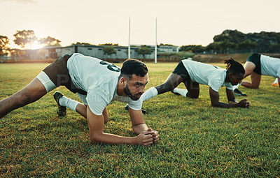 Buy stock photo Cropped shot of a group of young rugby players training on the field during the day