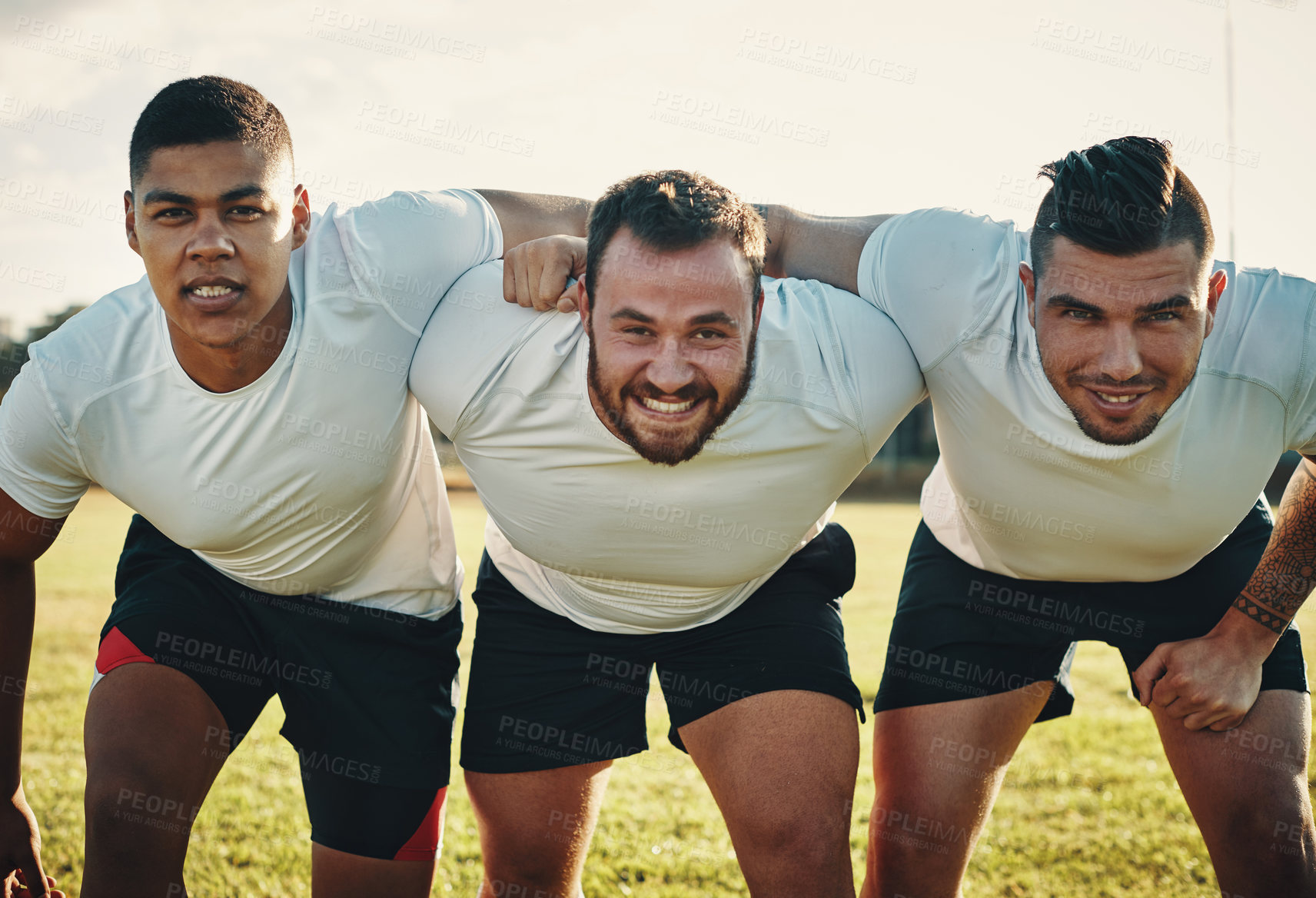 Buy stock photo Cropped portrait of a group of three young rugby players lining up for a scrum on the field during the day
