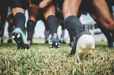 Buy stock photo Low angle shot of two unrecognizable rugby teams competing in a scrum during a rugby match on a field