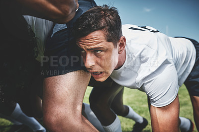 Buy stock photo Closeup of a focused young rugby player engaging in a scrum during a match outside on a filed