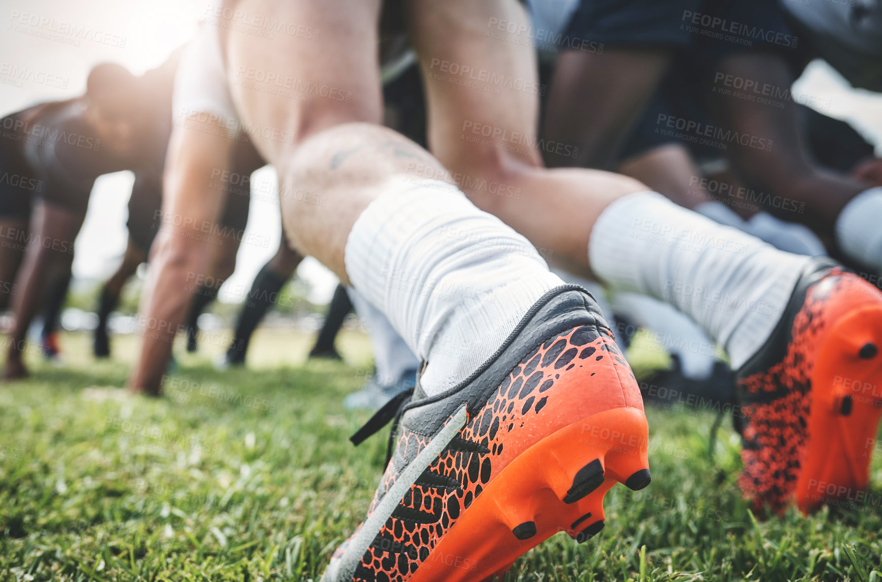 Buy stock photo Low angle shot of two unrecognizable rugby teams competing in a scrum during a rugby match on a field