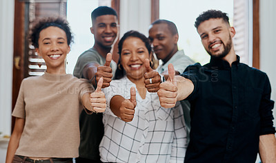 Buy stock photo Shot of a group of young businesspeople showing thumbs up in a modern office