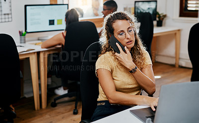 Buy stock photo Shot of a young businesswoman using a smartphone and laptop  in a modern office