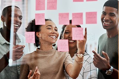 Buy stock photo Shot of a group of young businesspeople having a brainstorming session in a modern office