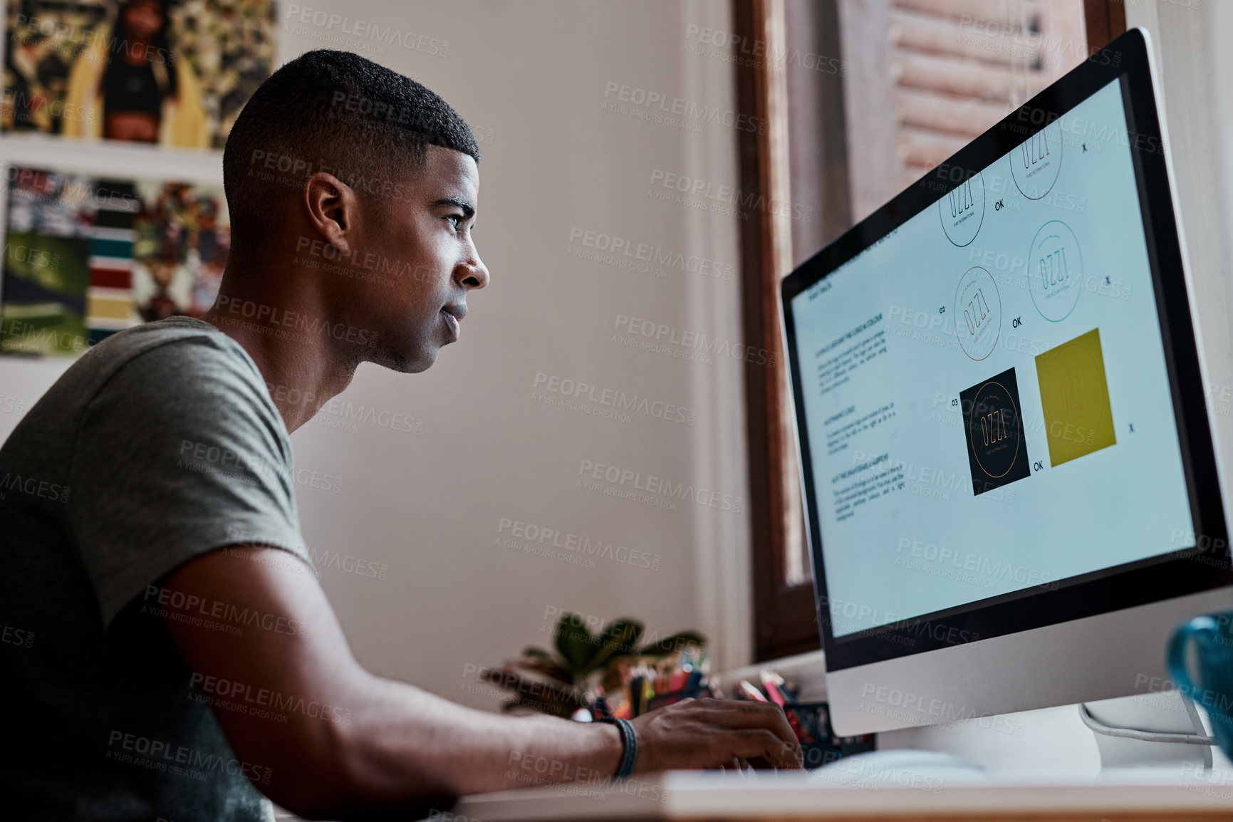 Buy stock photo Shot of a young businessman using a computer in a modern office