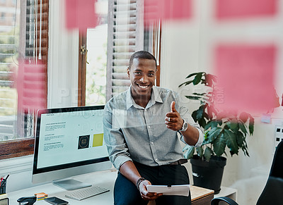 Buy stock photo Shot of a young businessman showing thumbs up in a modern office