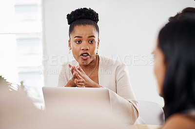 Buy stock photo Shot of a young businesswoman having a meeting with her colleague in an office