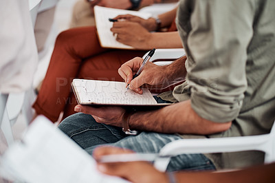 Buy stock photo Closeup shot of an unrecognisable businessman writing notes during a conference