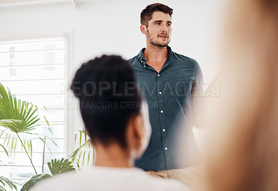 Buy stock photo Shot of a young businessman speaking at a conference