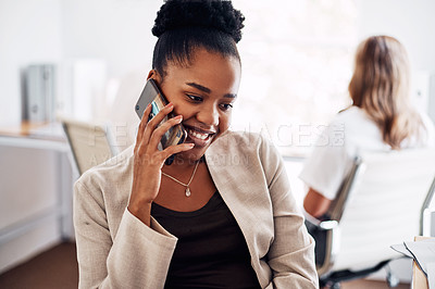 Buy stock photo Cropped shot of an attractive young businesswoman sitting in her office with her coworkers and using her cellphone