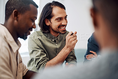 Buy stock photo Cropped shot of a diverse group of businesspeople sitting together and having a meeting in the office during the day