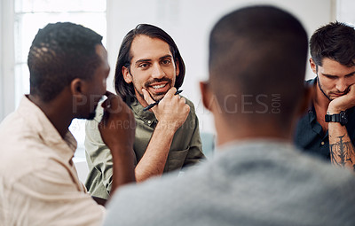 Buy stock photo Cropped shot of a diverse group of businesspeople sitting together and having a meeting in the office during the day
