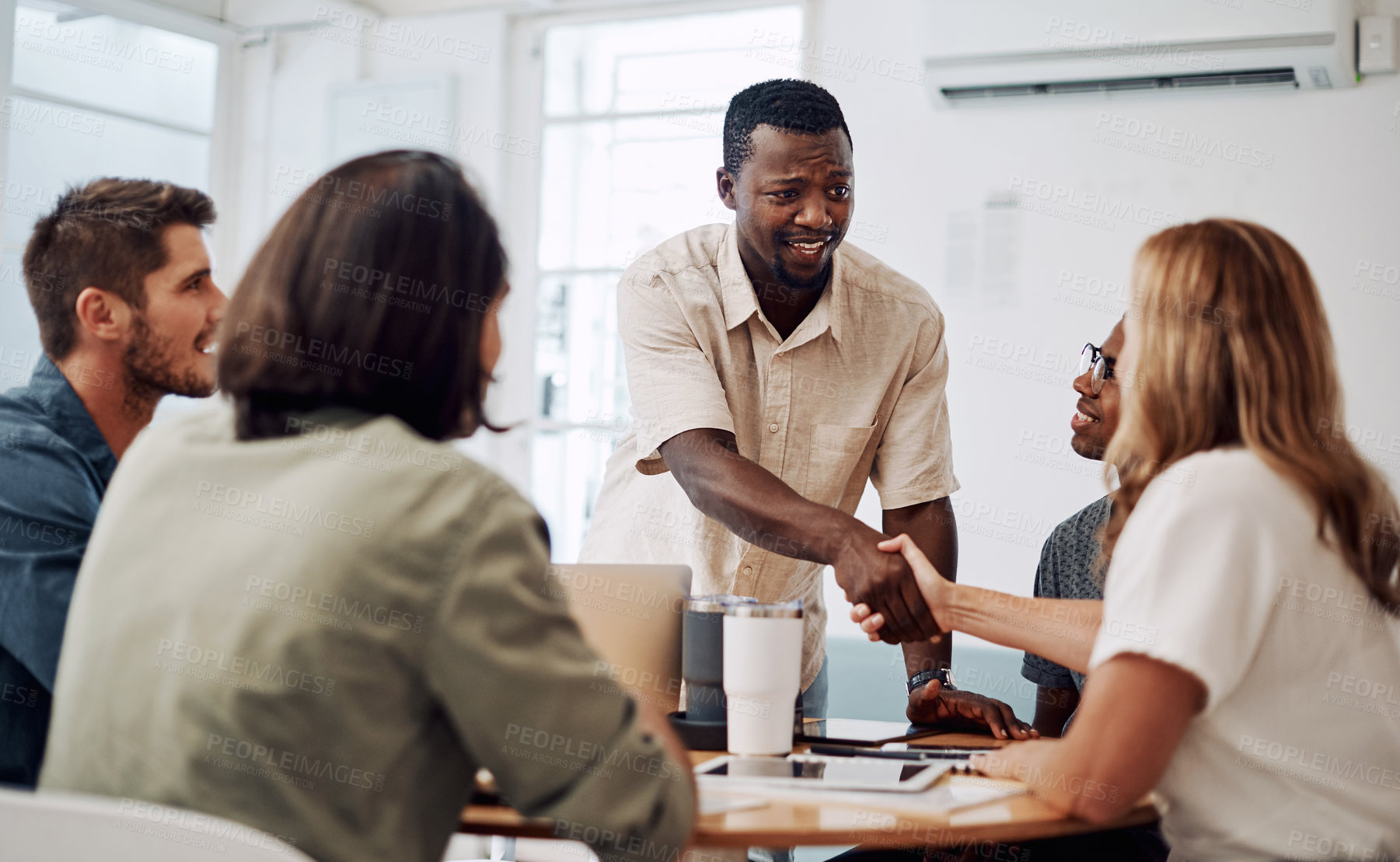 Buy stock photo Business people, handshake and meeting success with collaboration, teamwork or welcome to creative agency. Writer, editor or group manager shaking hands with young employee for editorial achievement