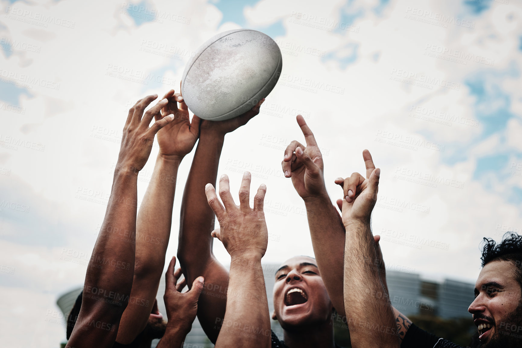 Buy stock photo Cropped shot of a team of rugby players celebrating while standing on the field during the day