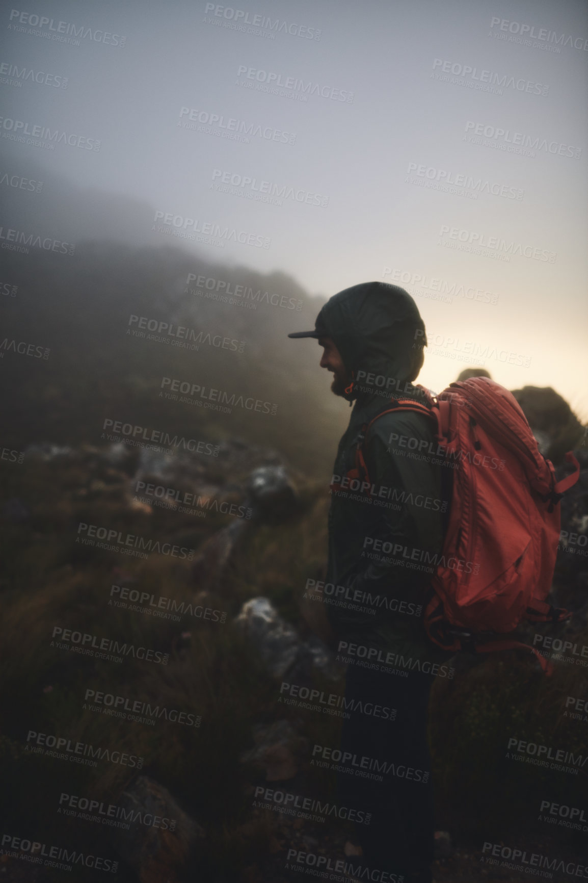 Buy stock photo Shot of a man looking happy while looking at the view from a mountaintop