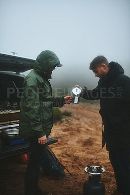 Buy stock photo Shot of two male friends having fresh coffee before hiking