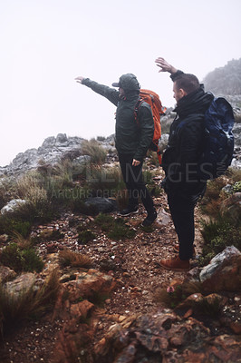 Buy stock photo Shot of two male friends looking at the view while out hiking in the mountains