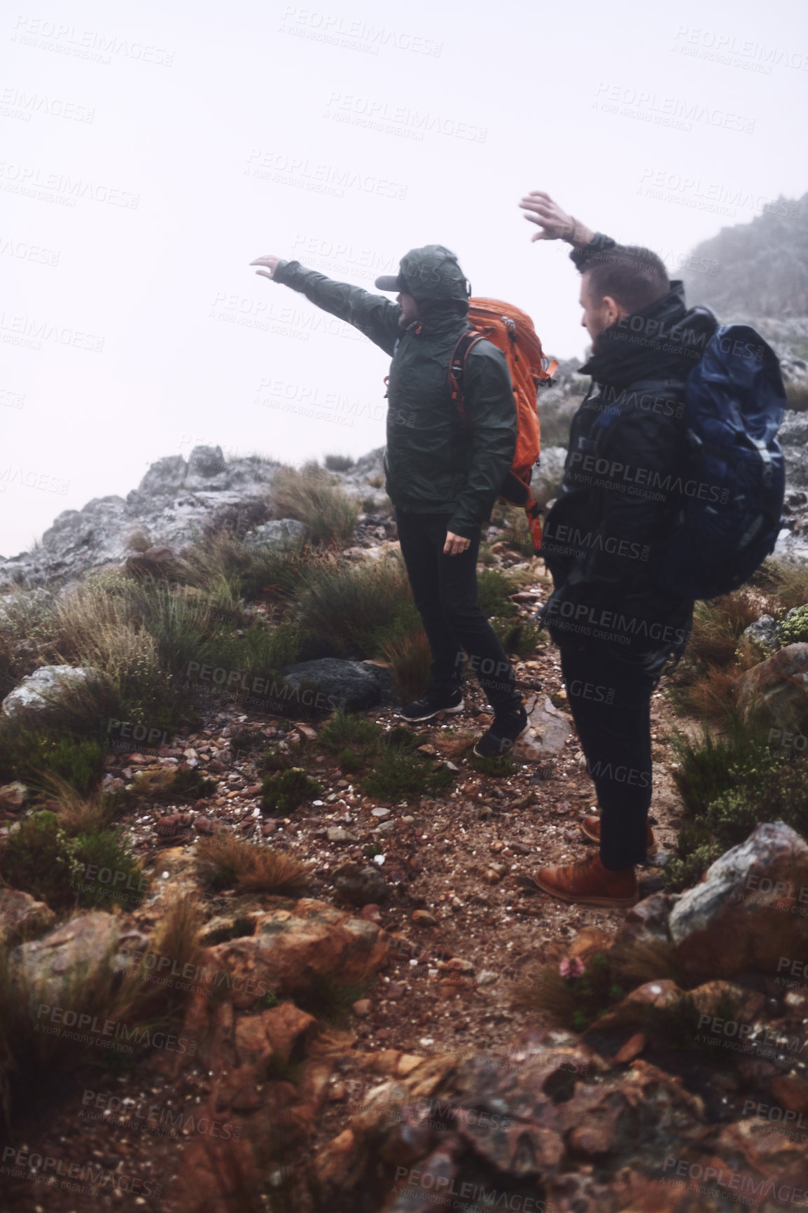 Buy stock photo Men, friends or pointing with mountain for hiking, backpack adventure or outdoor journey in mist. Male people, hikers or bag with path, cloudy sky or walking trail for trekking, travel or exploration