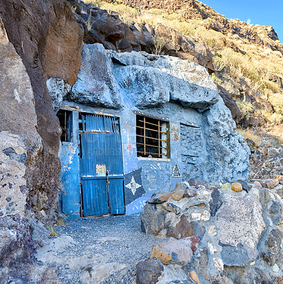 Buy stock photo Abandoned cave house with a wooden blue door close to Lol Llanos, La Palma on the Canary Islands. Rustic broken and aged entrance to a vacant home in a small village or town on a historical site