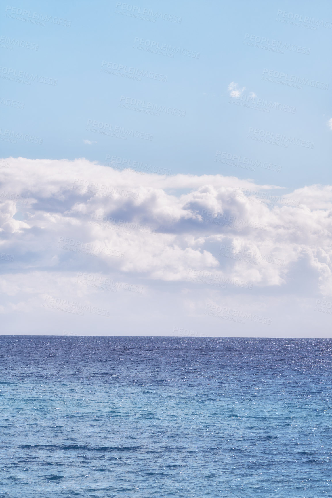 Buy stock photo A cloudy blue sky and peaceful, calm ocean separated by a beautiful horizon with copy space. Deep blue water underneath a cloudscape skyline. The many tides, currents and waves in the wide open sea