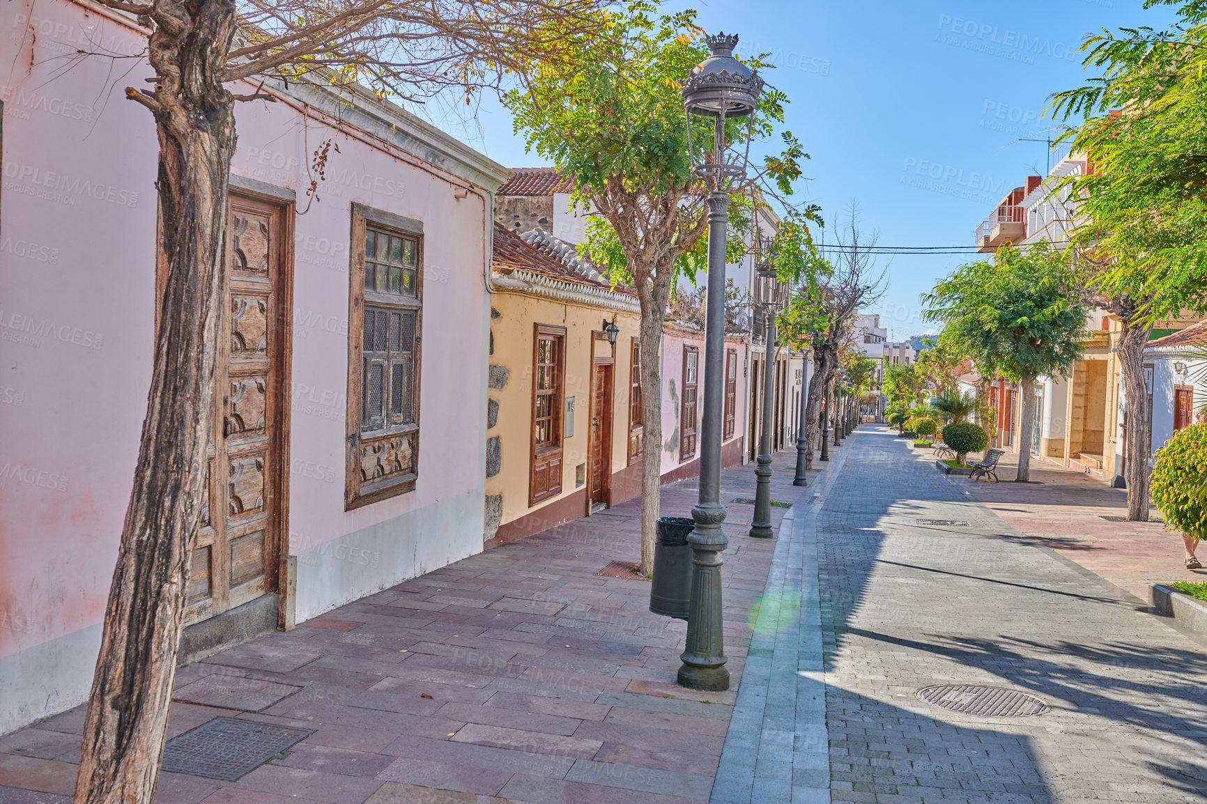 Buy stock photo Historical city street view of residential houses in small and narrow alley or road in tropical Santa Cruz, La Palma, Spain. Village view of vibrant buildings in popular tourism destinations overseas