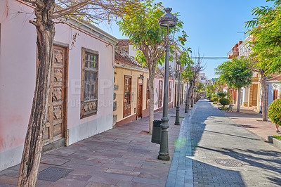 Buy stock photo Historical city street view of residential houses in small and narrow alley or road in tropical Santa Cruz, La Palma, Spain. Village view of vibrant buildings in popular tourism destinations overseas