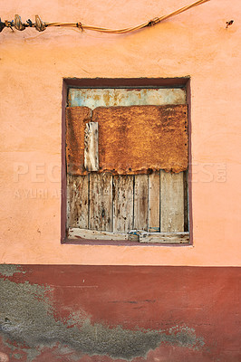 Buy stock photo Abandoned and bordered window on an empty house from poverty and economic crisis in Santa Cruz, La Palma, Spain. Wooden boards covering and blocking an old village home with damp mold on the walls