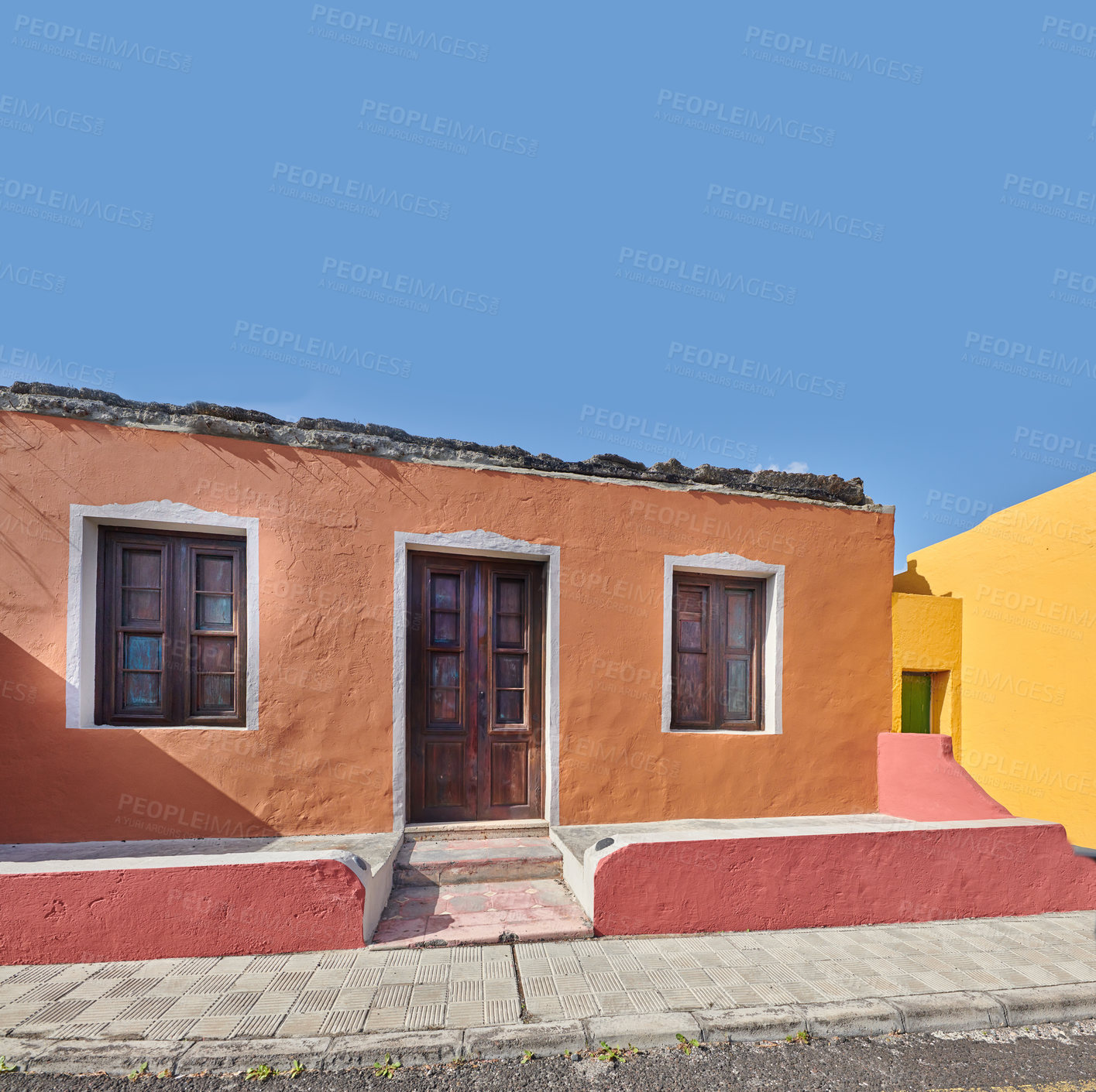 Buy stock photo Colorful building in a vibrant city of Santa Cruz de La Palma with clear blue sky copyspace background on a sunny day. Bright residential houses in a village of a popular tourism destination overseas