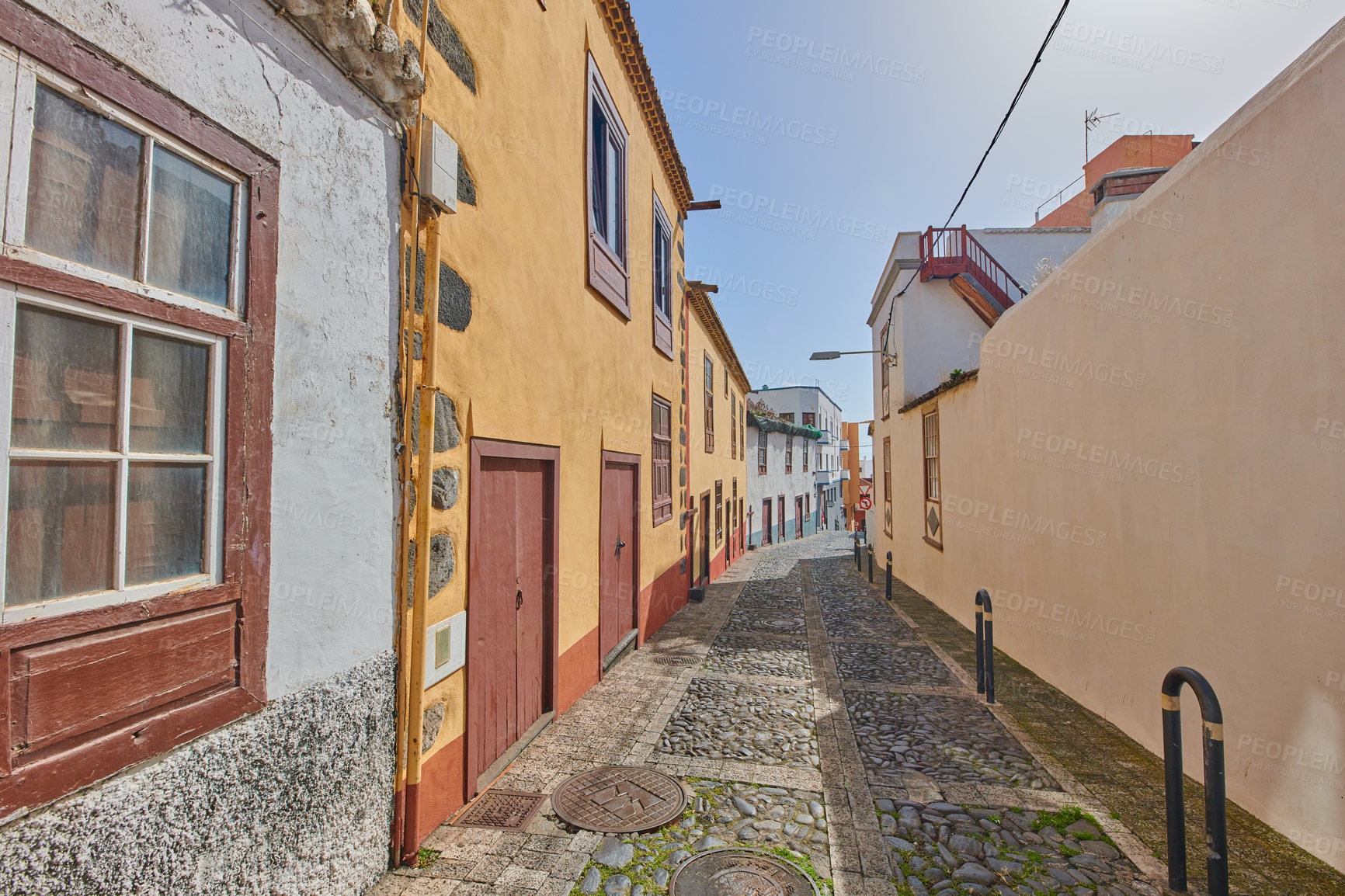 Buy stock photo Historical city street view of residential houses in small and narrow alley or road in tropical Santa Cruz, La Palma, Spain. Village view of vibrant buildings in popular tourism destinations overseas