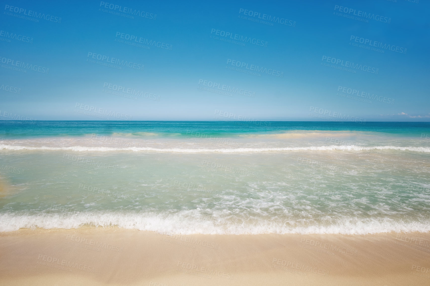 Buy stock photo Copy space at the sea with a clear blue sky background above the horizon. Calm ocean waters washing onto an empty beach shore. Peaceful scenic coastal landscape for a relaxing and zen summer getaway
