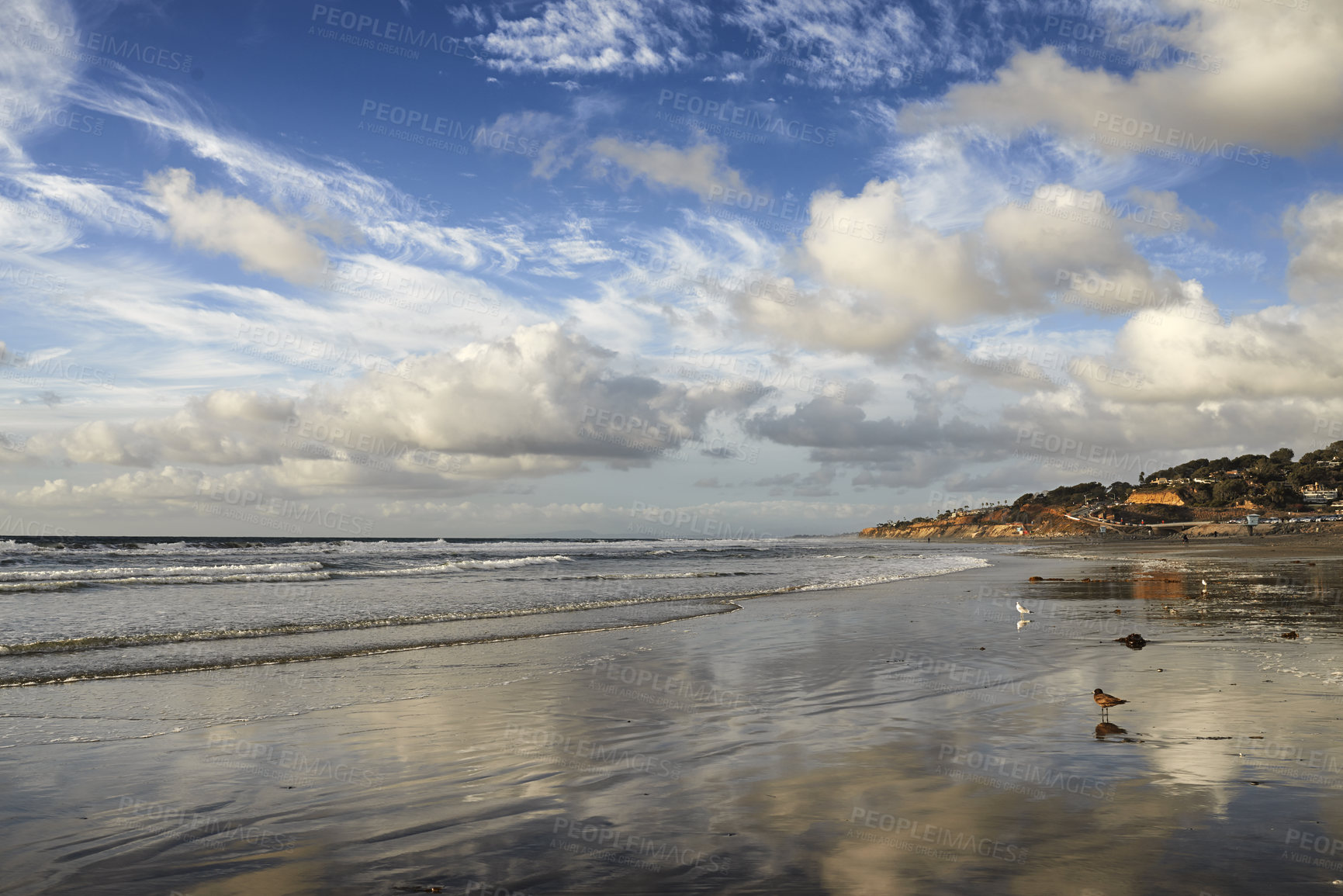 Buy stock photo Stunning beach landscape of the sea on a cloudy day with copy space. Calm waves at the shore on a quiet coastline with peaceful blue horizon. Scenic nature at travel location in San Diego, California
