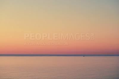 Buy stock photo Seascape of a beautiful golden sunset with copy space. Sun setting on the horizon of a calm ocean at dusk or twilight. The calm and tranquil ocean or sea in the evening with bright sky copyspace