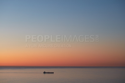Buy stock photo Cargo ship on calm sea at sunset