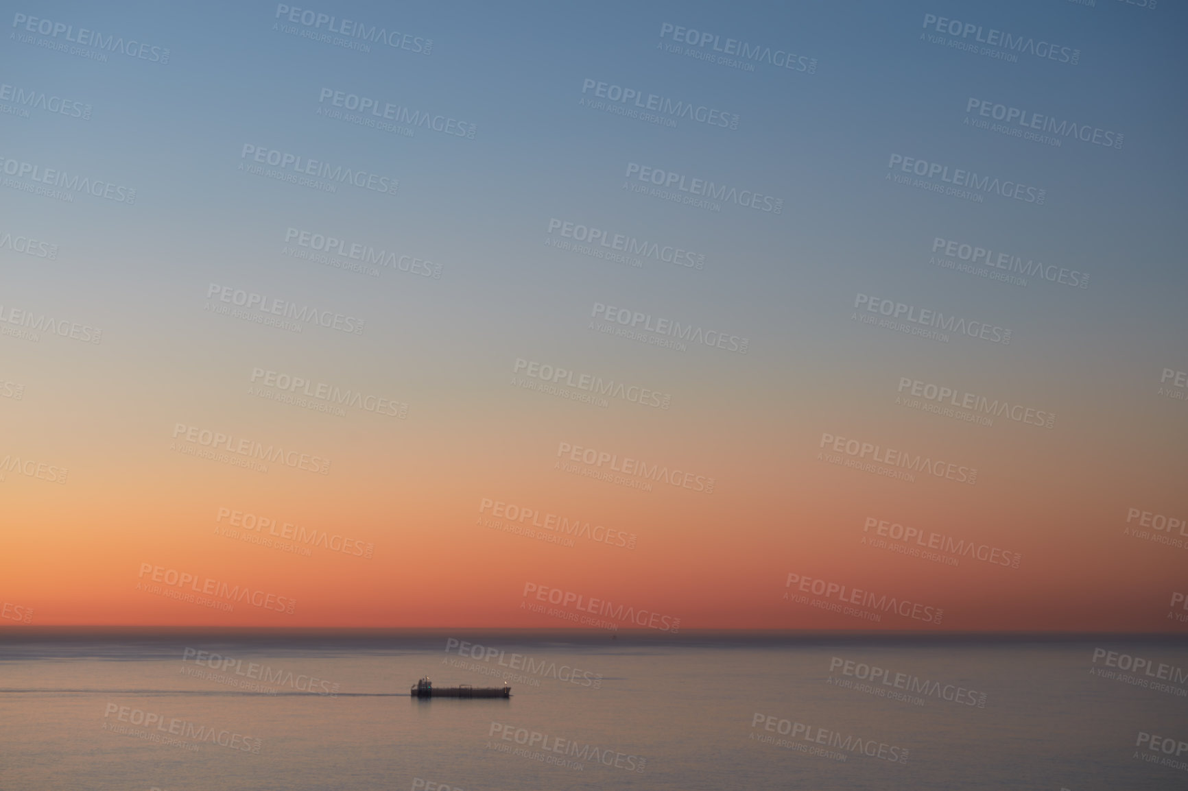 Buy stock photo Cargo ship on calm sea at sunset