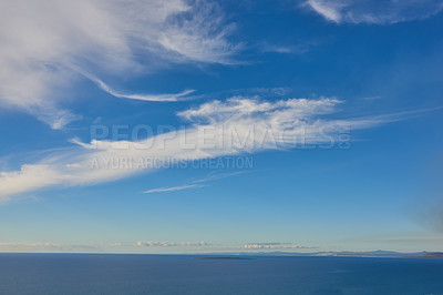 Buy stock photo Copy space and deep blue sea with a cloudy sky background above the horizon. Peaceful scenic coastal landscape for a relaxing and zen summer getaway. A wide open seascape background of a beach