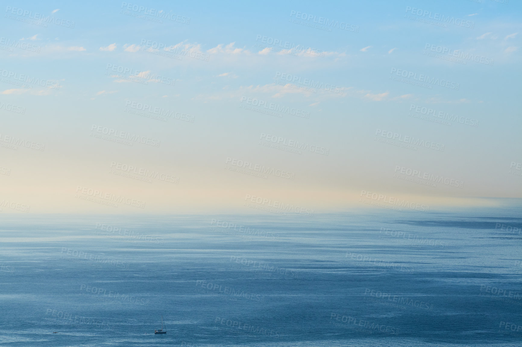 Buy stock photo An empty ocean with a blue sky and copy space. A wide open seascape background of a beach with calm water. Scenic sea surface with calming ripples and the rising morning sun on the horizon