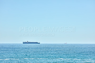 Buy stock photo A cargo ship cruising in the deep blue sea, freight and logistics against clear blue sky copyspace background. Drone view of import export commerce business using marine vessel to transport product