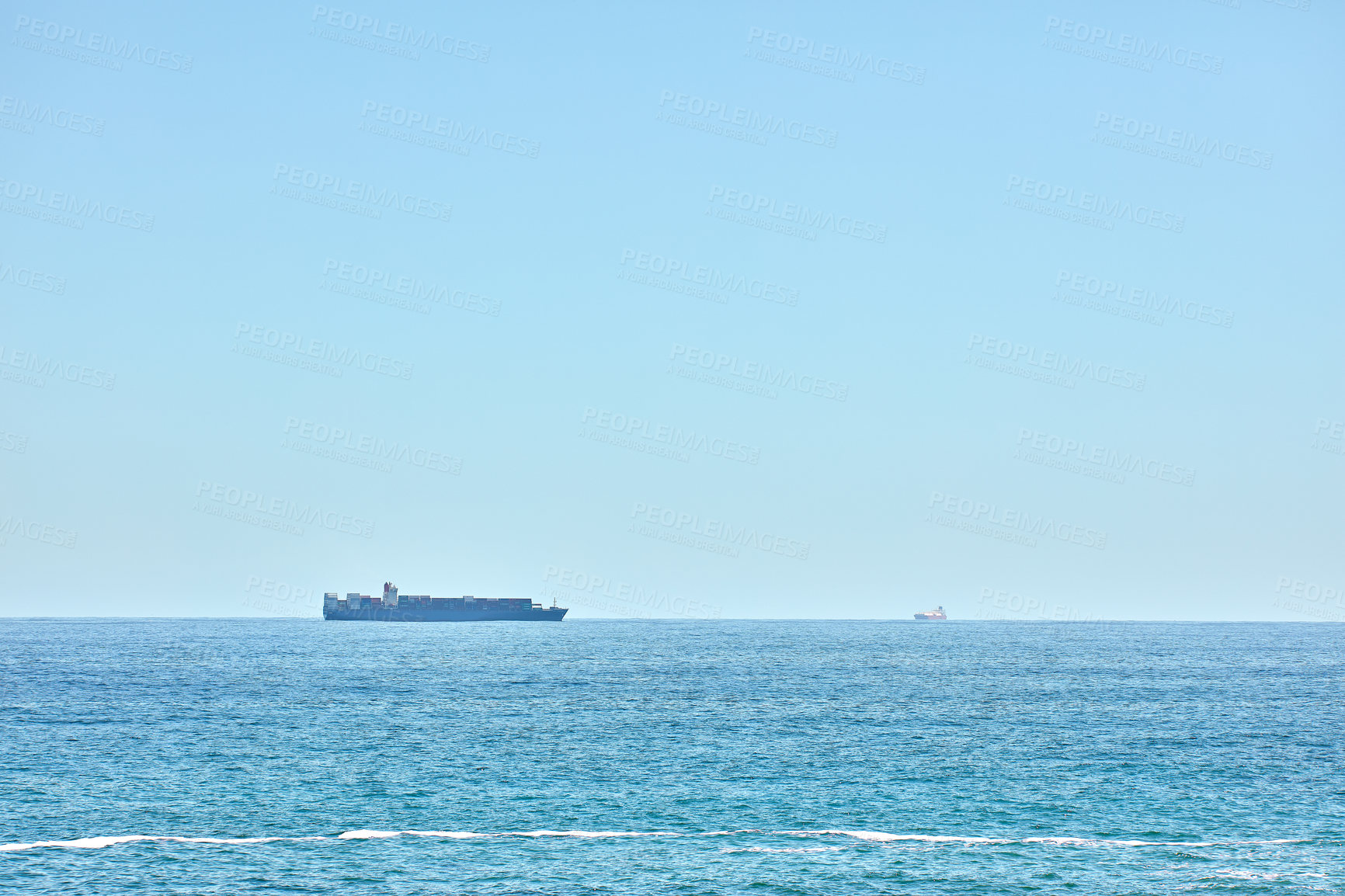 Buy stock photo A cargo ship cruising in the deep blue sea, freight and logistics against clear blue sky copyspace background. Drone view of import export commerce business using marine vessel to transport product