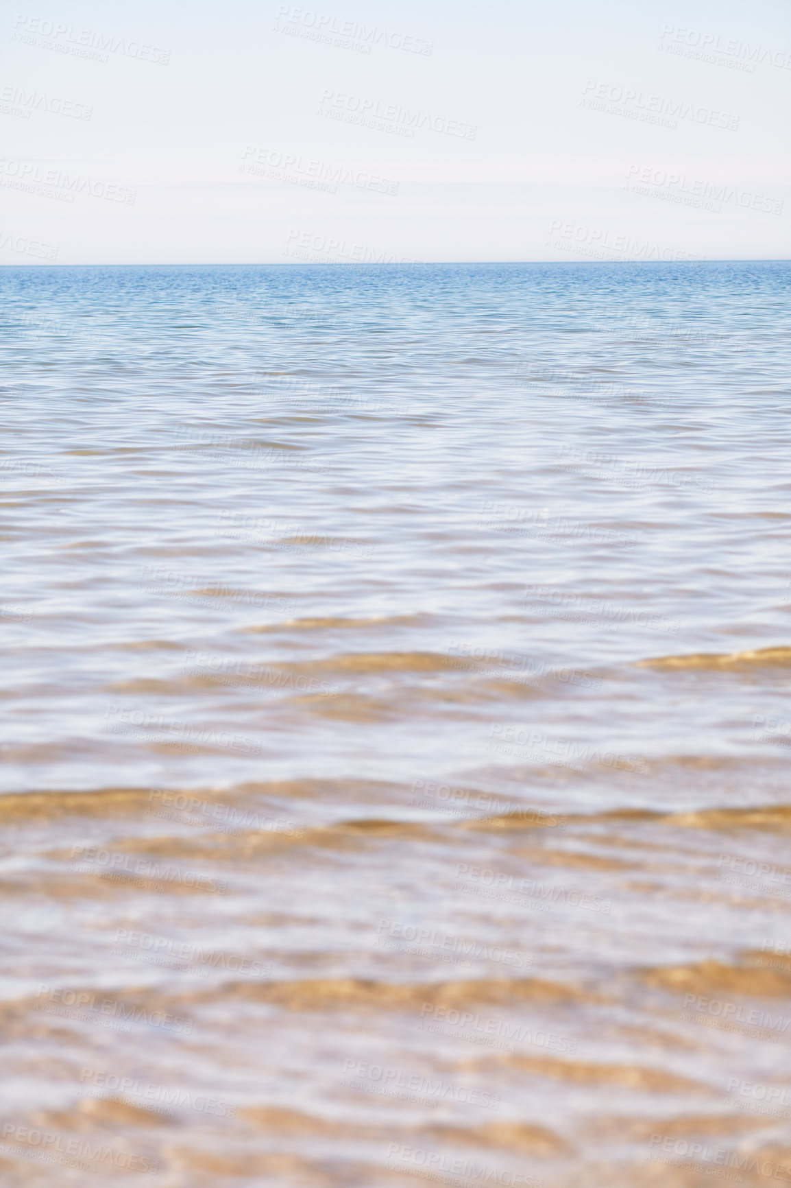 Buy stock photo Copy space at the sea with a clear blue sky background above the horizon. Calm ocean waters at an empty beach. Peaceful and scenic coastal landscape for a relaxing and zen summer getaway in nature