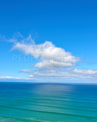 Buy stock photo Beautiful cumulus clouds in a blue sky over a calm blue sea and ocean in summer. Gorgeous scenic view of the beach and blue water during the day. Idyllic and peaceful coastline for a summer vacation