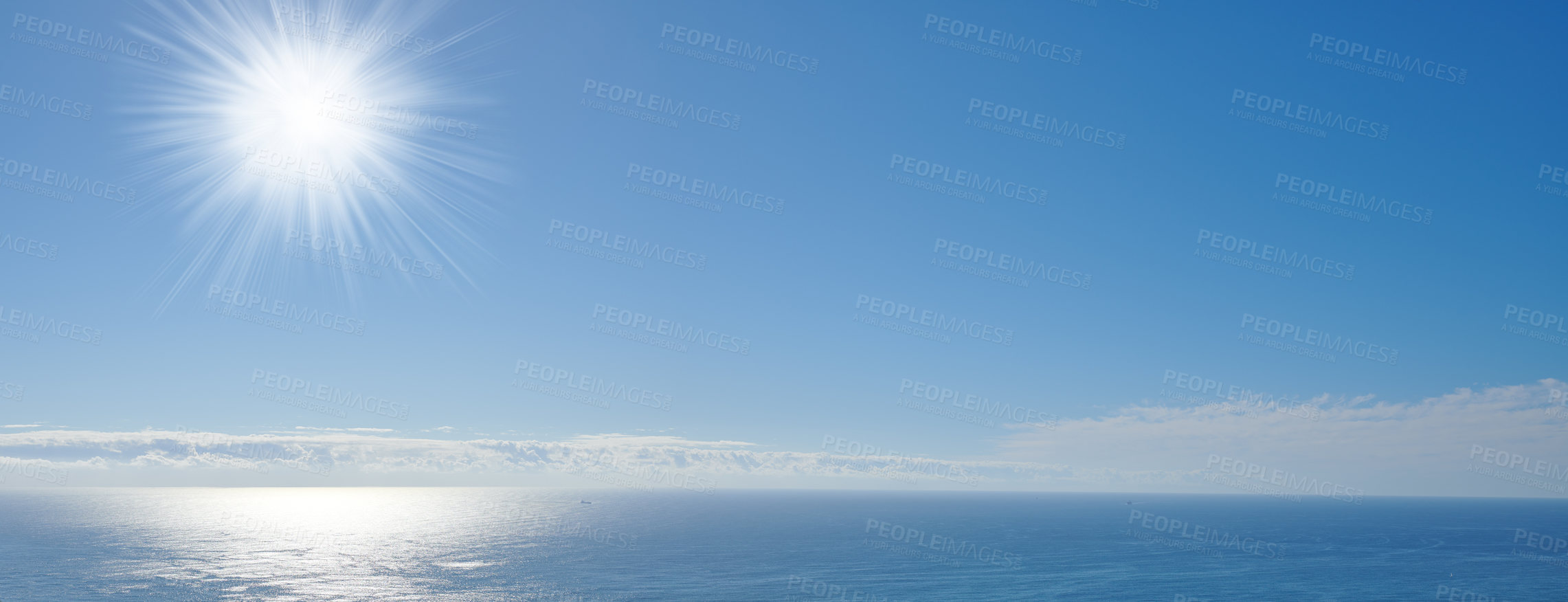 Buy stock photo Copy space at sea with a clear blue sky and the sun in the background. Calm ocean tide on an open ocean. A scenic seascape for a relaxing summer holiday with cloudy sky and clean water on the coast